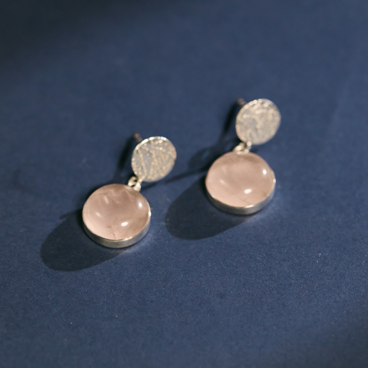 Premium rose quartz jewelry gift. Genuine sterling silver pink stone earrings displayed on luxury navy velvet, an ideal anniversary or birthday gift for her.