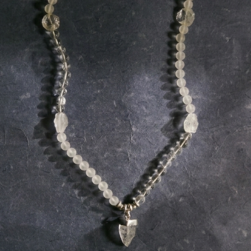 A macro detail shot of the Crystal Mala, illustrating the precise alternating sequence of "satin-finish" frosted beads and "ice-clear" raw rock crystal shards on a silk cord.