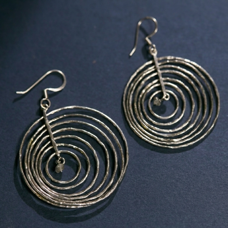 Top-down view of the 925 silver Celestial Orbit earrings showing the symmetrical orbital design and high-quality silver finish.