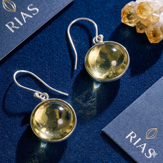 Stunning 925 sterling silver citrine drop earrings featuring honey-gold natural gemstones. These high-polish silver dangles are the perfect statement piece for a luxury jewelry collection.